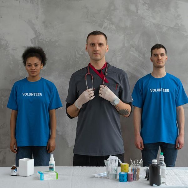 A diverse group of people smiling and preparing for an indoor cardio session.